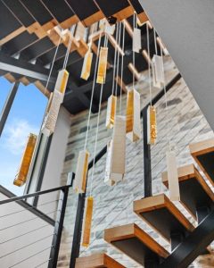 SunBeam cascading pendant lights suspended from double-height ceiling