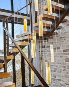 Vibrant SunBeam pendant chandelier above modern floating stairs