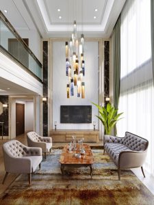 TV area with luxurious seating furniture in a classic interior with large windows and high ceilings.