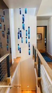 Sea-glass SunBeam cascading lights for luxury oceanfront entryway