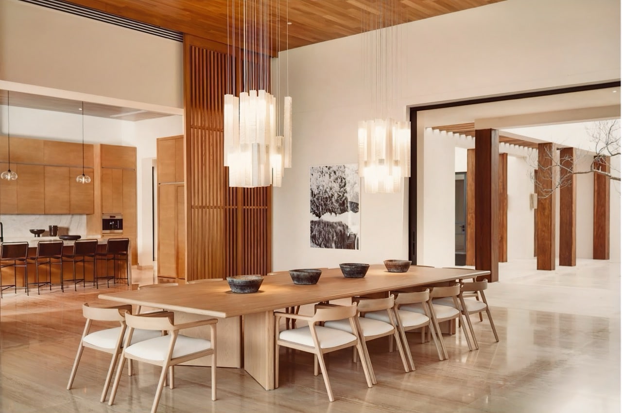 Custom art glass chandelier suspended over marble dining table