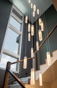 Custom SunBeam pendant lights above grand staircase