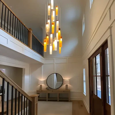 Elegant SunBeam art glass chandelier in double-height foyer crafted in multi-color glass